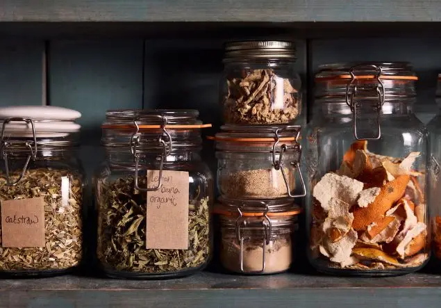 A variety of ingredients in glass jars for herbal remedies